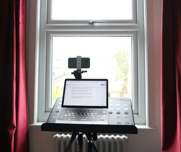 use a tripod to hold your phone and your laptop as a teleprompter