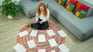 Photo of someone sitting on the floor with lots of papers around them
